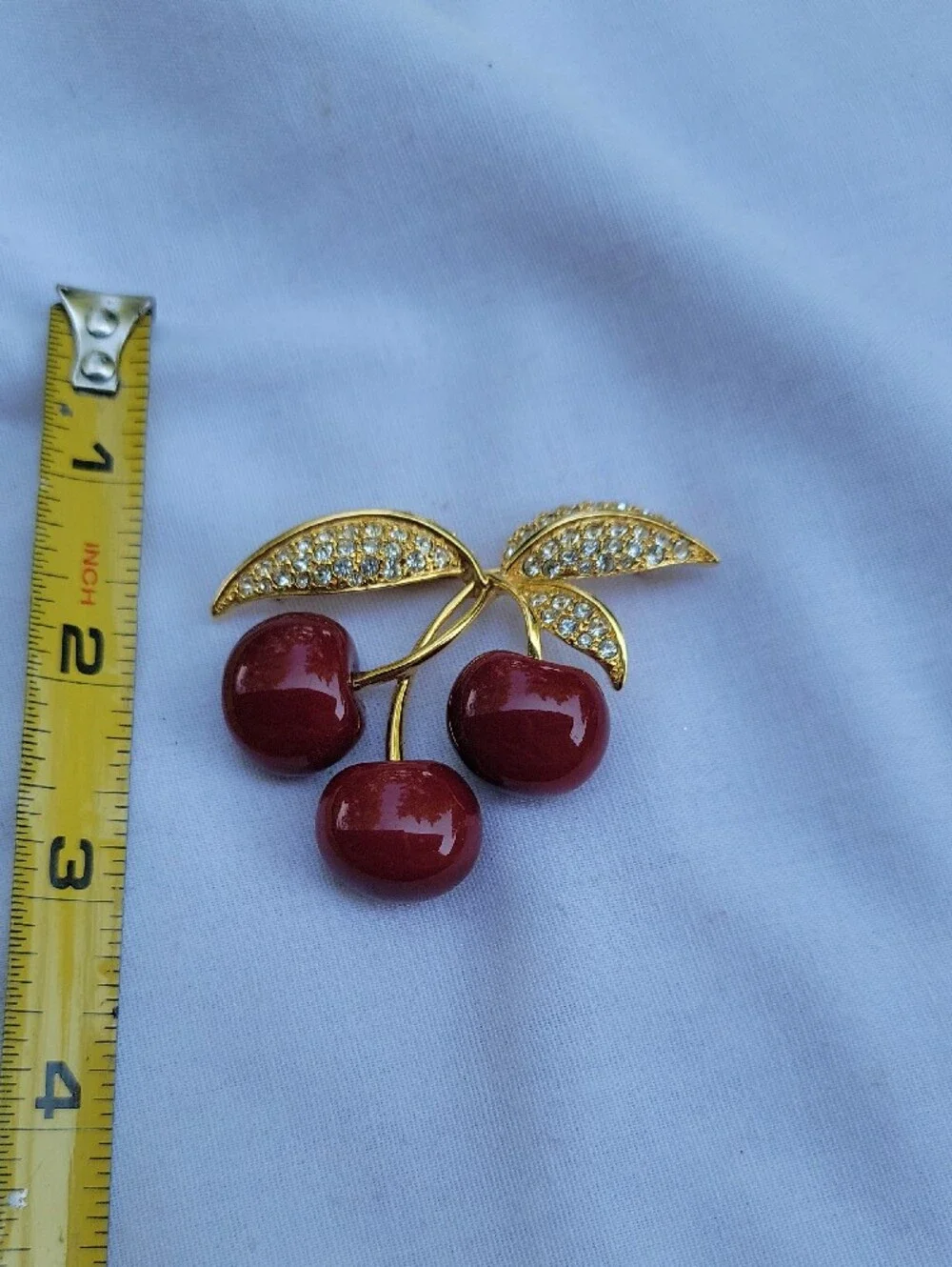 Vintage Joan Rivers Gold-Tone Red Lucite? Cherry Brooch with Crystal Leaves